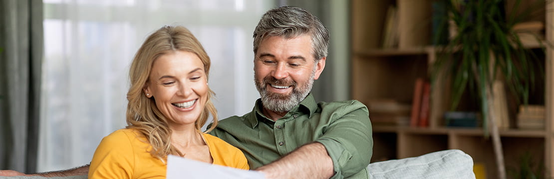 Caucasian couple reading documents.